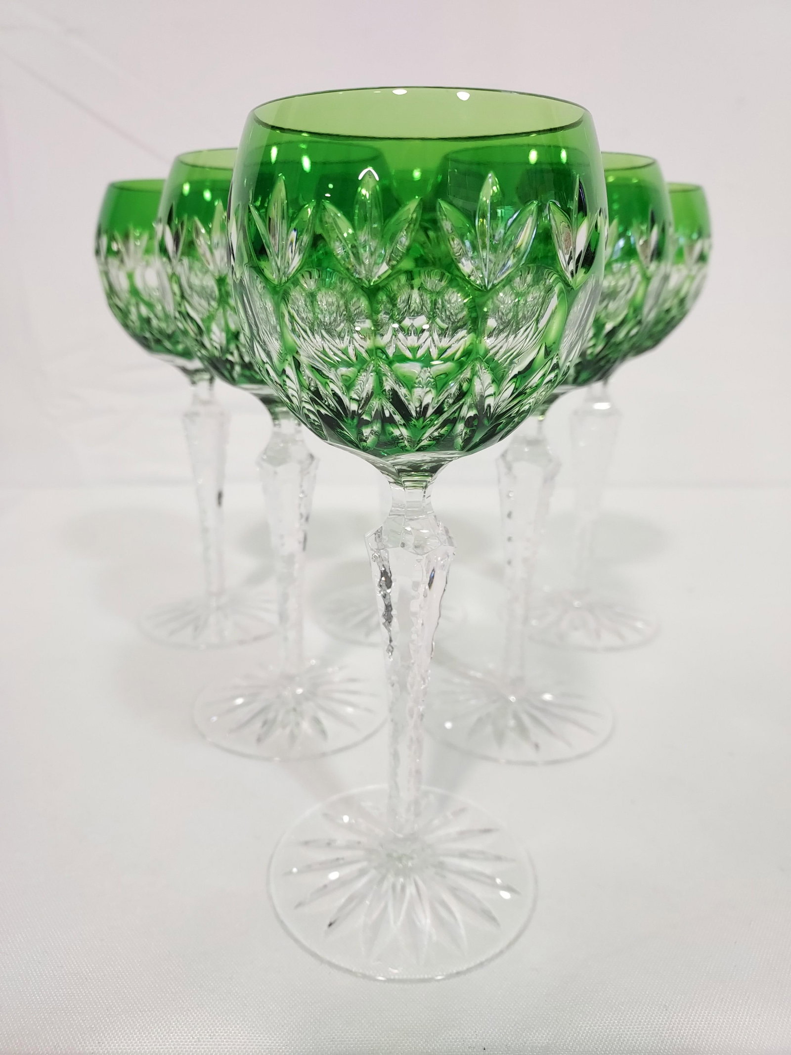SIX GREEN OVERLAY CUT CRYTAL RHINE WINE STEMS: Six green overlay cut to clear crystal Rhine wine stem glasses. Each measures 8" tall x 3" wide. Condition: good without chips, cracks, or repairs. Shipping weight: 3 lbs