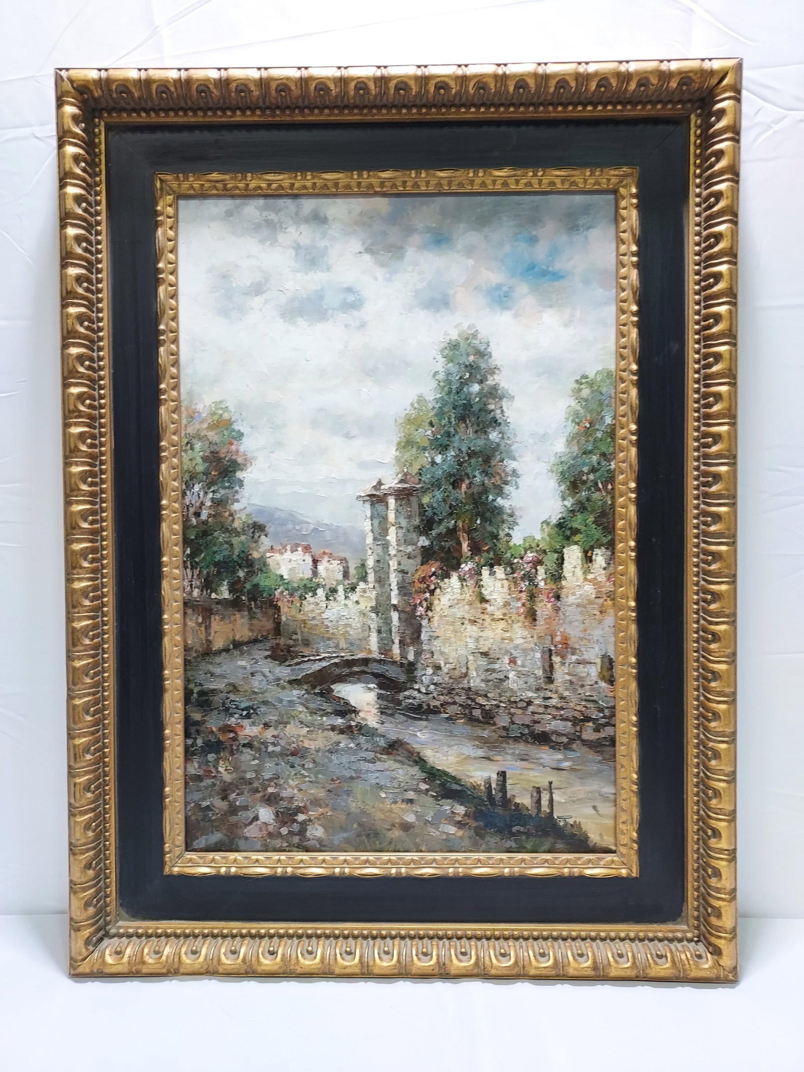 VINTAGE FRAMED ITALIAN STYLE OIL ON CANVAS PAINTIN: Vintage Italian style framed oil on canvas painting, depicting an outdoor scene with buildings and a bridge. Signed "Christina J." lower right. Measures (frame) 47" tall x 35" wide, and (sight) 35.5" 