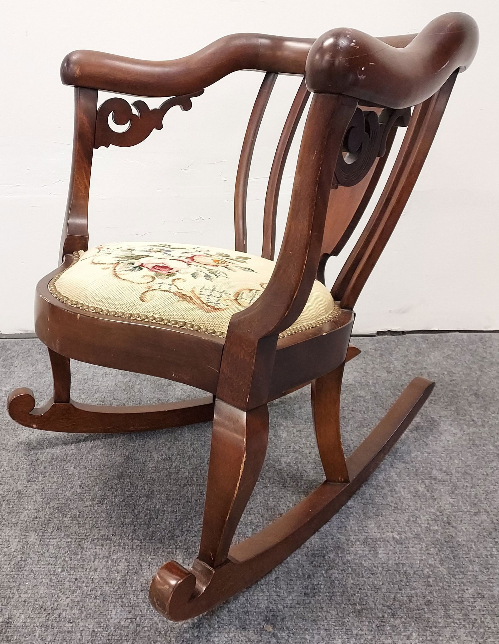 VINTAGE EMPIRE STYLE WALNUT ROCKING CHAIR: Vintage Empire style walnut rocking tub chair. Measures 31" tall x 27" wide and approx. 37" deep. Needlepoint upholstered seat. Condition: minor scattered signs of age, repair to left arm, scattered s