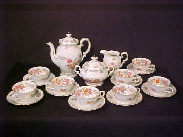 21 PIECE BAVARIAN DEMITASSE SET PORCELAI: 8 cups and saucers. Saucers 4 1/2", cups 4" wide x 1 3/4" high, sugar 6" wide x 4 1/2" high, creamer 4" high x 4 1/2" high and coffee pot 7" high x 7" wide.