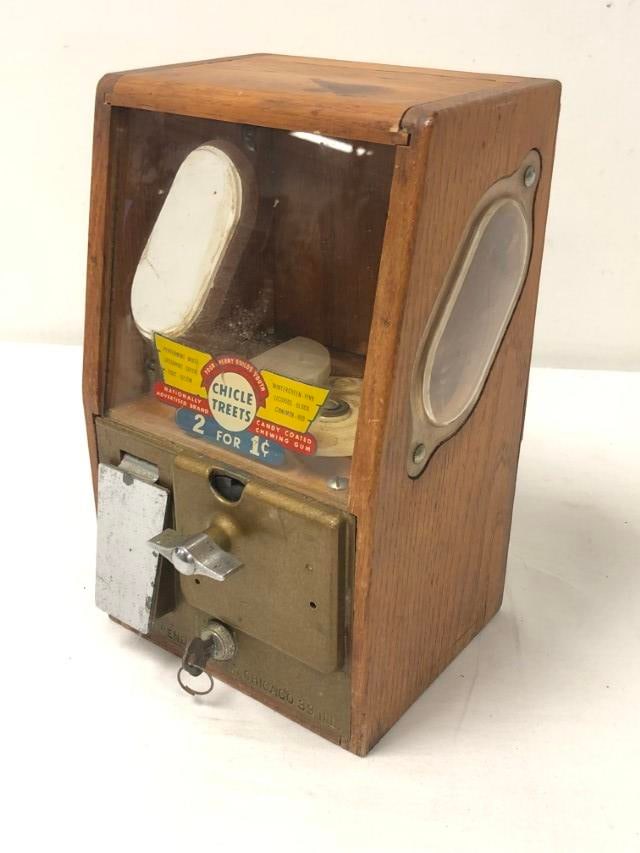 VNTG VICTOR VENDING "CHICLE TREETS" VENDING MACHIN: Vintage Victor Vending "Chicle Treets" wooden vending machine measuring 11.5" tall x 7" wide and 7" deep. Condition: crack to left side acrylic window, mechanism is working, small loss to veneer on ba