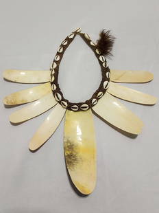 LARGE AFRICAN SHELL CHOKER NECKLACE: A large likely ceremonial choker style necklace of woven cotton, shells, and fur. Measures: 14" x 14". Condition: good.