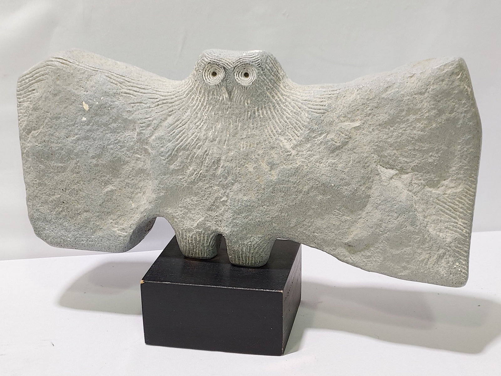 ROGER CHARLES CAVALLI FAUX STONE SCULPTURE OWL: Roger Charles Cavalli faux stone sculpture of an owl. Signed on the side "Cavalli", and near base "MPI 1961". Measures 11" tall x 18" wide and about 6" deep. Condition: small amount of paint loss to w