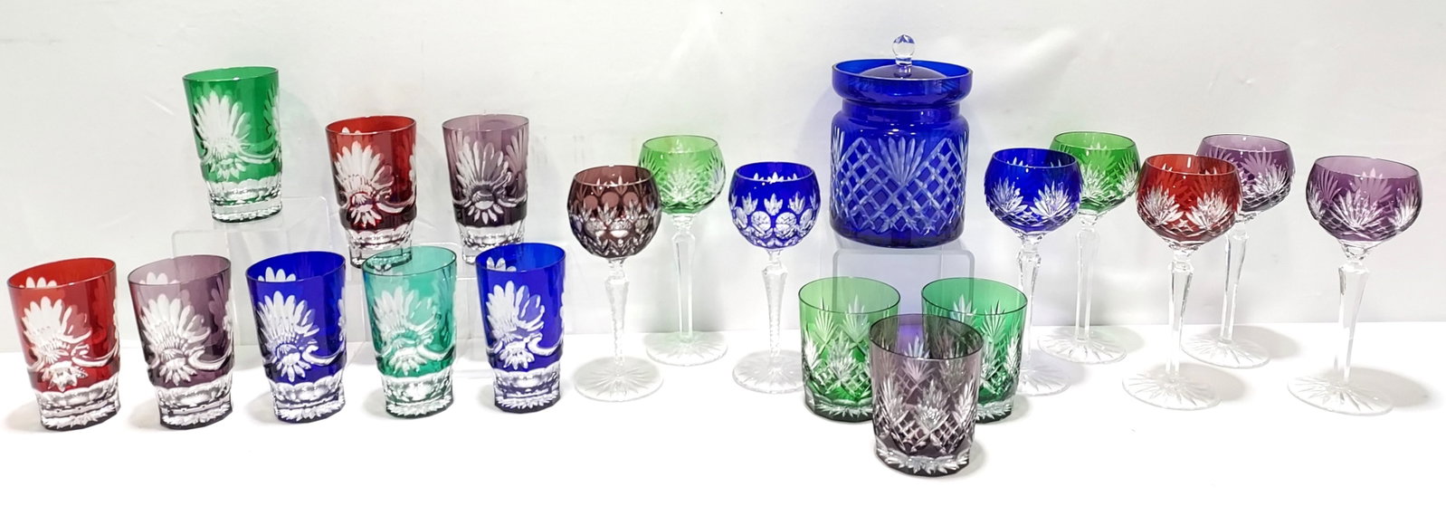 20PC CUT TO CLEAR WINE TUMBLERS OLD FASHION ROCKS: Twenty cut to clear wine stems and bar ware glasses in various patterns and colors. Tumblers (high balls) with etched mark for Design Guild on base. Lot consists of: eight 8.5" wine stems, two 8" wine