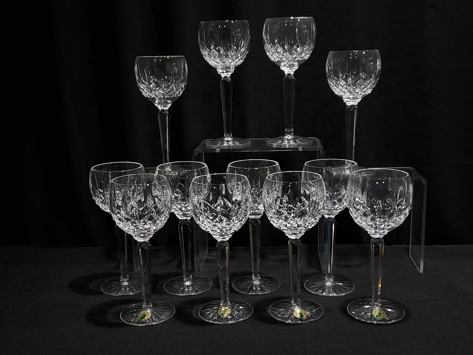 12 WATERFORD CRYSTAL LISMORE HOCK WINE STEMS: Twelve classic Waterford Lismore pattern balloon style Hock wine glasses. Each measures 7.5" tall x approx 3" wide. All marked with Waterford etched mark on base. Includes 2 boxes which hold 2 stems e