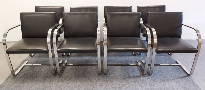 EIGHT BRNO BY KNOLL FLAT ARM DINING CHAIRS: Lot of eight flat arm dining chairs by Miles Van Der Rohe for Knoll (BRNO). Chrome finish frame with a black leather upholstery. Each chair measures 31.5" tall x 23" wide and 23" deep. Condition: unma