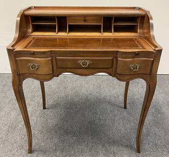 PETIT LOUIS XV STYLE LEATHER TOP WRITING DESK: Petit Louis XV style leather top writing desk measuring 34.75" tall x 30" x 19.5" deep. Pull out / extendable writing surface with embossed leather. Various storage compartments above the writing surf