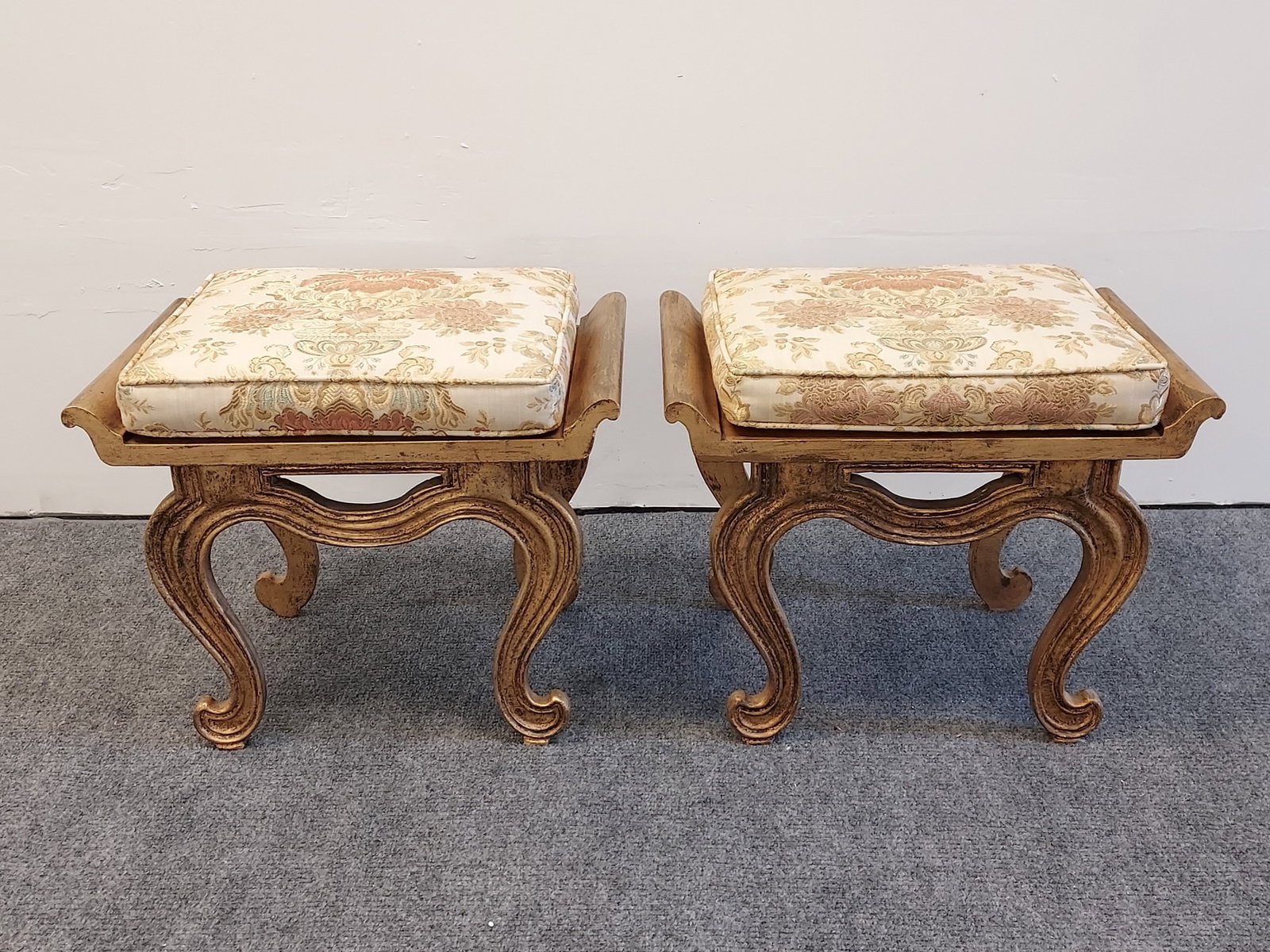 PAIR FRANCISCO HURTADO GILTWOOD BENCH SEATS: Pair of Francisco Hurtado giltwood bench seats with floral brocade cushions. Manufacturer paper label attached to base. Each bench measures 15.5" tall without cushion, or 16.5" tall with cushion, x 20