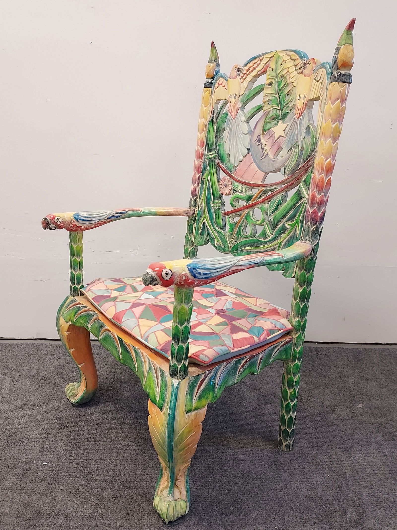 TROPICAL MEXICAN CARVED WOOD PARROT THEMED ARMCHAI: Tropical Mexican carved and painted wood parrot themed armchair. Measures 49.5" tall x 29.5" wide and 26" deep. Marked "Hecho en Mexico" under the removable parrot form finials. Matched seat cushion.