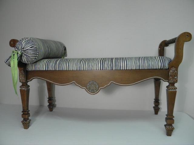 A FRENCH PROVINCIAL STYLE BEDROOM BENCH: French Provincial-style bedroom bench. Carved wood design with barley twist arms on each end, and blue and white striped upholstery with an included cylindrical pillow. Condition: very minor nicks to 