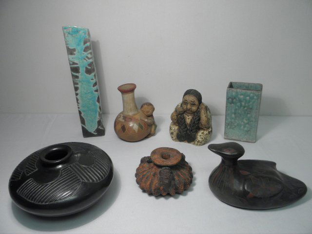 ASSORTED ART POTTERY: MEXICAN, ETC. 7 PCS: Lot of assorted art pottery. Includes a Mexican red/orange bottle vase with a figural face motif, an etched pottery figural bottle vase, a carved black basalt pottery low vase, a Mexican art pottery f