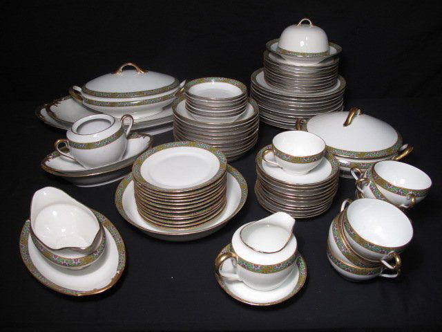 LIMOGES "TRIOMPHE" DINNERWARE: 80 PCS: Superieur Limoges "Triomphe" porcelain dinnerware set. Floral and geometric decorated rim with gilt highlights. Includes 10 bowls (2"h x 7.5"w), 11 saucers (6"w), 9 cups (6" w), 8 condiment bowls (1.5