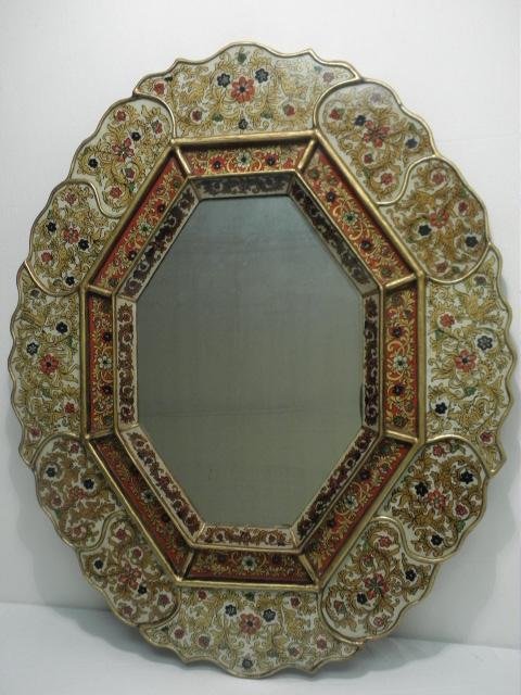 PERUVIAN REVERSE PAINTED EGLOMISE WALL MIRROR: Peruvian reverse painted wall mirror. Gilt edges, with floral eglomise panels of reverse painted glass in gold, red, blue, and white. Condition: very minor clouding to mirror, see images. Measures 32.