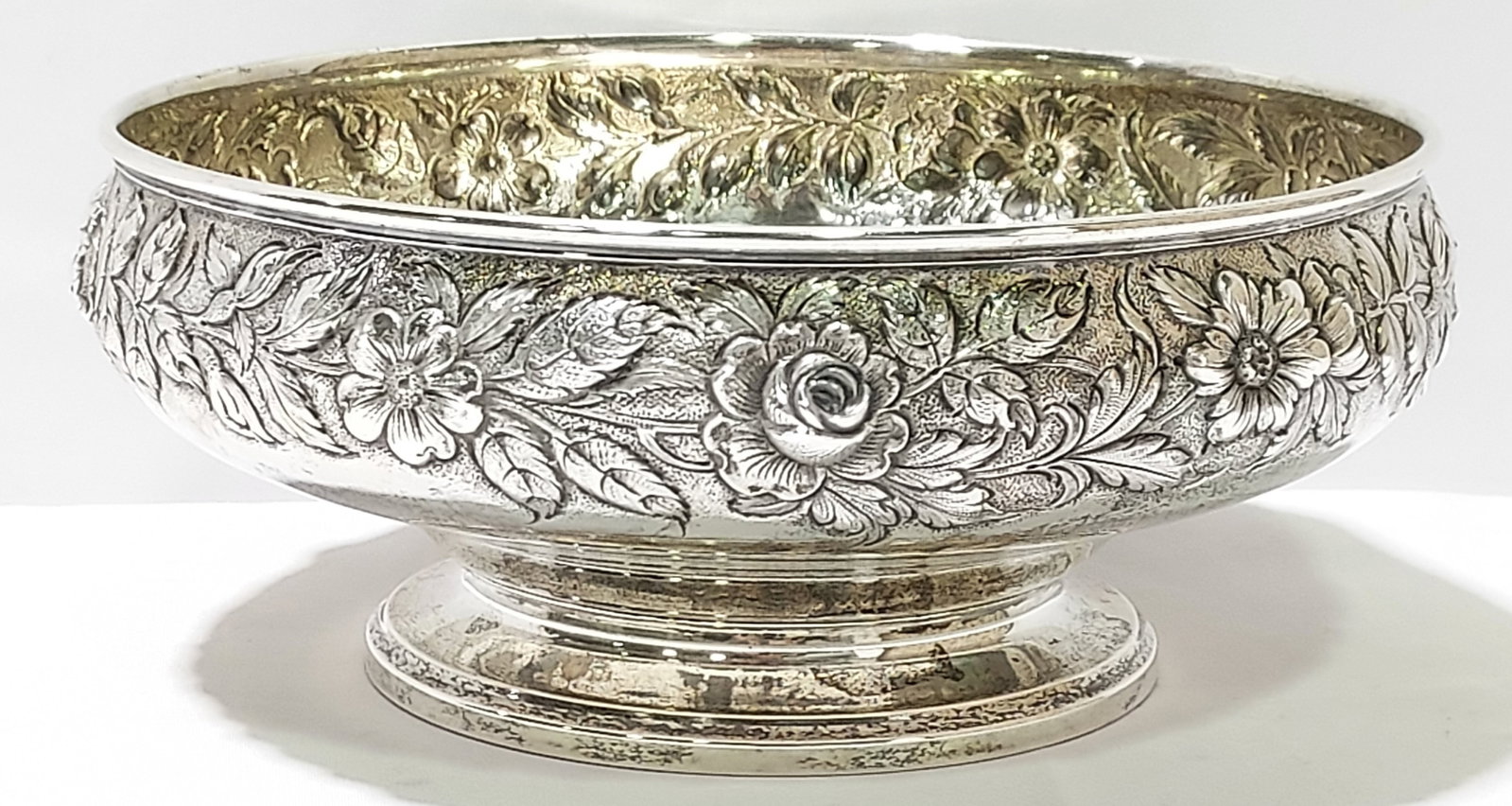 S KIRK & SONS FLORAL EMBOSSED STERLING SILVER BOWL: S. Kirk & Sons floral embossed sterling silver footed bowl measuring 3.75" tall x 9.25" diameter. Marked accordingly on base. Condition: good, no dents or large scratches, light signs of normal use, s