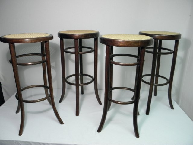 FOUR BENTWOOD & CANE STOOLS: Lot of four bentwood and cane stools in the manner of Thonet. Bentwood frame with cane seats. Condition: good, joints need minor tightening, see images. Each stool measures 29" tall x 15" wide. Total 