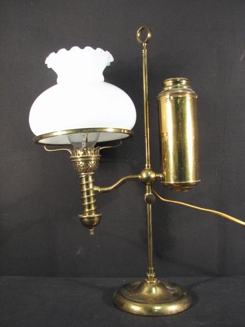 BRASS & GLASS ELECTRIFIED STUDENT OIL LAMP: An electrified brass student oil lamp with a white glass shade. Original oil reservoir, with an adjustable lamp height. Does not appear to be marked. Condition: very minor tarnishing, dings/dents, may