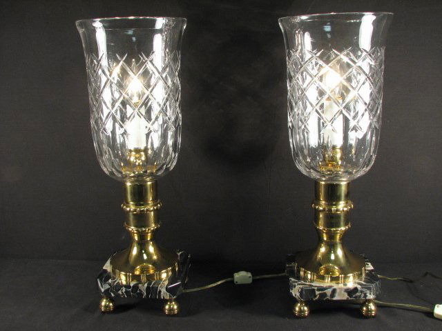 PAIR CUT CRYSTAL & MARBLE HURRICANE STYLE LAMPS: Pair of Waterford style cut crystal and marble hurricane style lamps. Mounted with a brass stem, square cut marble base, and four brass ball feet. Condition: very minor flakes to a few corners of marb