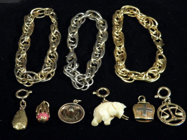 ASSORTED BRACELETS & CHARMS: 14K, 18K GOLD, ETC.: Lot of assorted ladies bracelets and charms. Includes: (3) chain link bracelets (one gold tone, one gold and silver tone, one silver tone), a gold Swiss bell charm (stamped on attached loop "750"), a