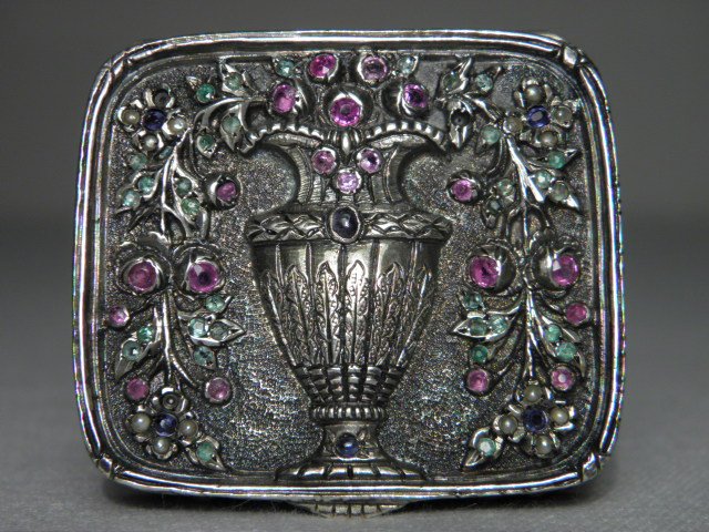 CONTINENTAL JEWELED & EMBOSSED SILVER SNUFF BOX: A continental silver snuff box (or trinket box), most likely Russian. Embossed, engraved, with applied jewel decorations and a gold washed interior. Cover features a floral urn motif with emeralds, ru