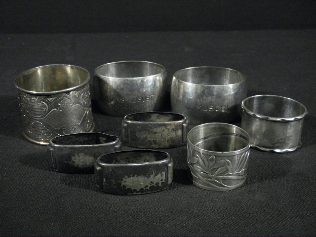EIGHT CONTINENTAL SILVER NAPKIN RINGS - 4.95 TROY: Lot of eight assorted continental silver napkin rings. Includes a set of (3) .835 silver napkin rings (monogrammed and numbered 1 to 3), a pair of (2) .835 hammered silver oval rings (personally engra