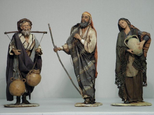 THREE MIXED MEDIA SCULPTURES OF TRAVELLERS: Lot of three continental mixed media sculptures depicting travellers, two men and a woman. Hand sculpted and painted, each signed on base with what appears to read "A. Zeipi". Condition: good, see ima