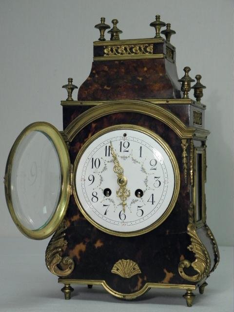 FRENCH F. MARTI BOULLE STYLE SHELF CLOCK: A 19th century French Boulle style shelf clock made by F. Marti. Original brass movement, pendulum, convex glass face, and bell strike, with an enameled Arabic numeral dial and gilded openwork hands. 