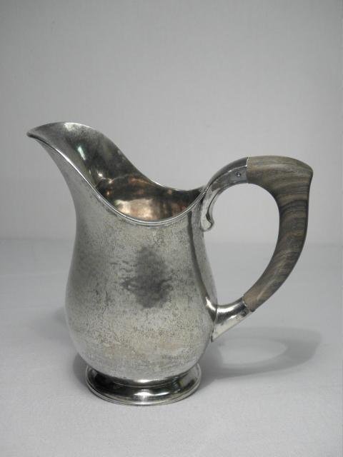 J. DIX BONN SCANDINAVIAN .830 SILVER WATER PITCHER: Scandinavian hammered .830 silver water pitcher made by J. Dix Bonn. Wooden attached handle, pitcher stamped on base "J. Dix Bonn 830", with German silver import marks. Condition: small dent to base, 