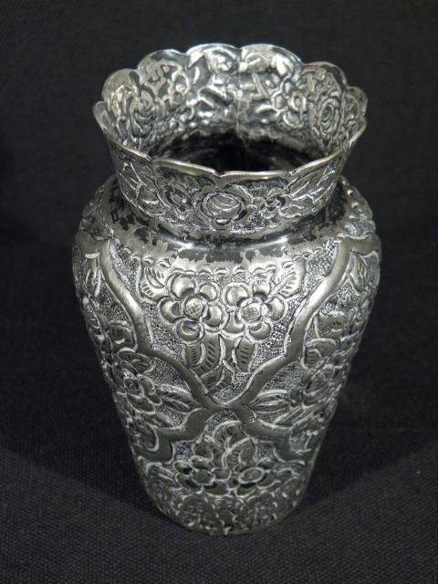 SMALL MIDDLE EASTERN EMBOSSED SILVER VASE: A small middle eastern silver vase. Floral embossed pattern, marked on base twice with "80". Tests positive for silver content. Condition: very minor tarnishing and wear, see images. Measures 3.75" ta