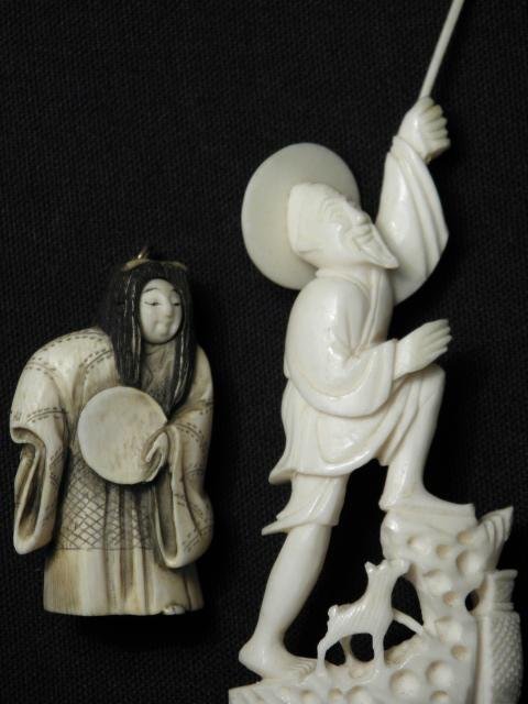 JAPANESE CARVED IVORY TRICK NETSUKE & CHINESE FISH: A Japanese carved ivory "Actor" trick netsuke, along with a Chinese carved ivory figure of a fisherman with a dog. The trick (or Karakuri) netsuke is black highlighted, signed on base, and mounted to 