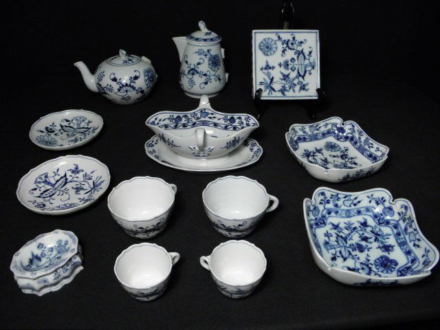 ASSORTED MEISSEN & OTHER "BLUE ONION" DINNERWARE: Lot of assorted Meissen and other "blue onion" patterned porcelain dinnerware. Includes a gravy boat (broken handle) by C. Teichert Stove, a Meissen footed square trivet (chip to edge), a Meissen cond