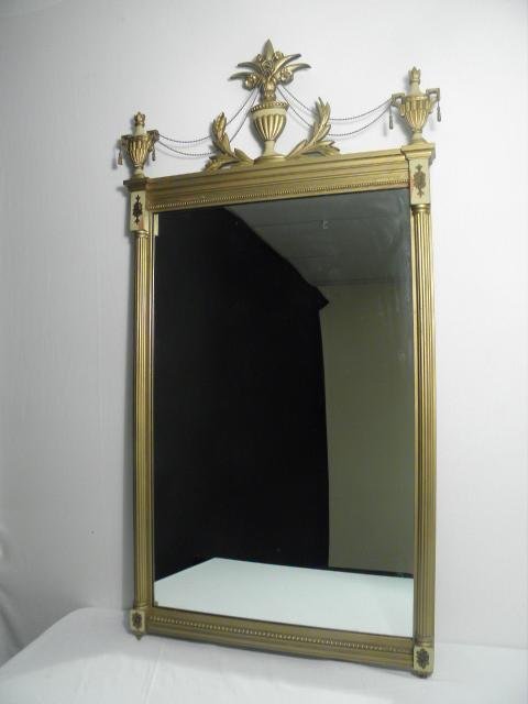 FEDERAL STYLE WALL MIRROR: Federal style wall mirror, hand painted with a gold tone and small floral friezes in each corner. Two urn form finials in each top corner, both connected with hanging chains to a center foliate urn fi
