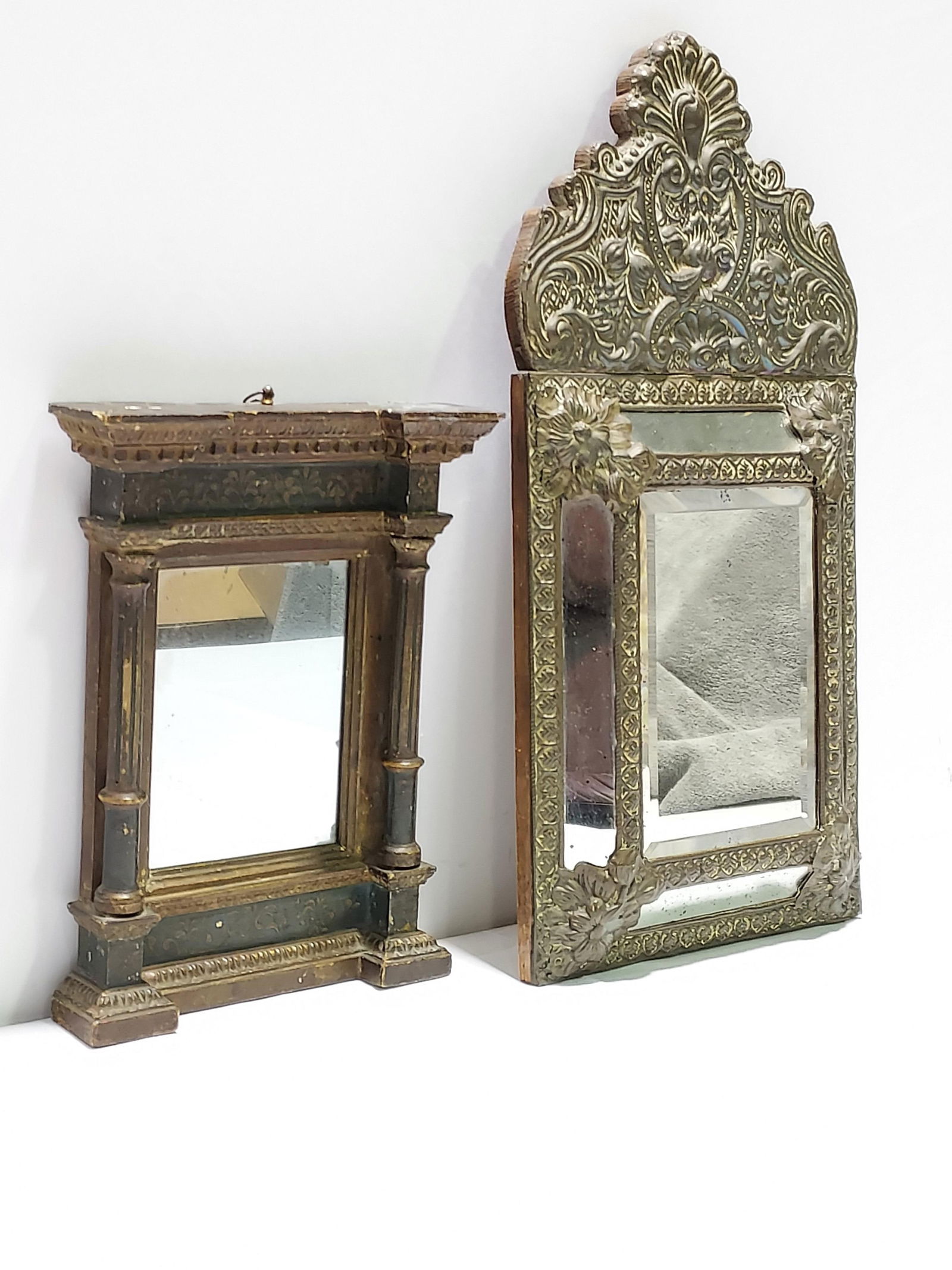 2 ANTIQUE MIRRORS: A COLUMNAR AND AN EMBOSSED META: Two antique mirrors. One a small wood architectural style mirror with columns on each side, painted frieze and plinth, Greek Key and other molding trim. 12.25" x 9.25" x 2.25". Condition: general wear