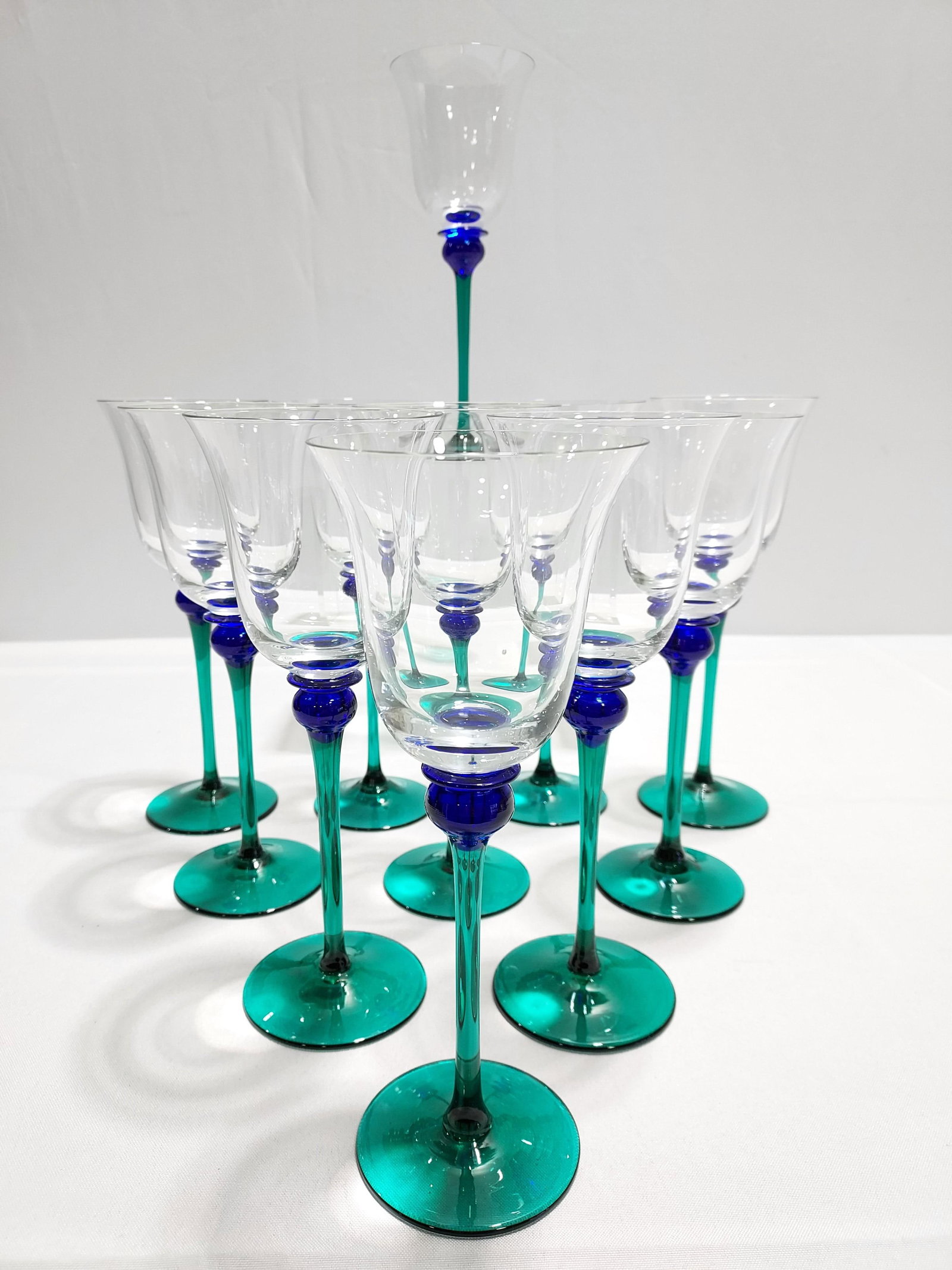 ELEVEN MAZZORBO ITALIAN ART GLASS STEMS / GLASSES: Lot of eleven Mazzorbo Italian hand blown art glass stems or glasses. Each one measures about 9.75" tall, but the exact sizes will vary slightly due to the fact that each one is made by hand and uniqu