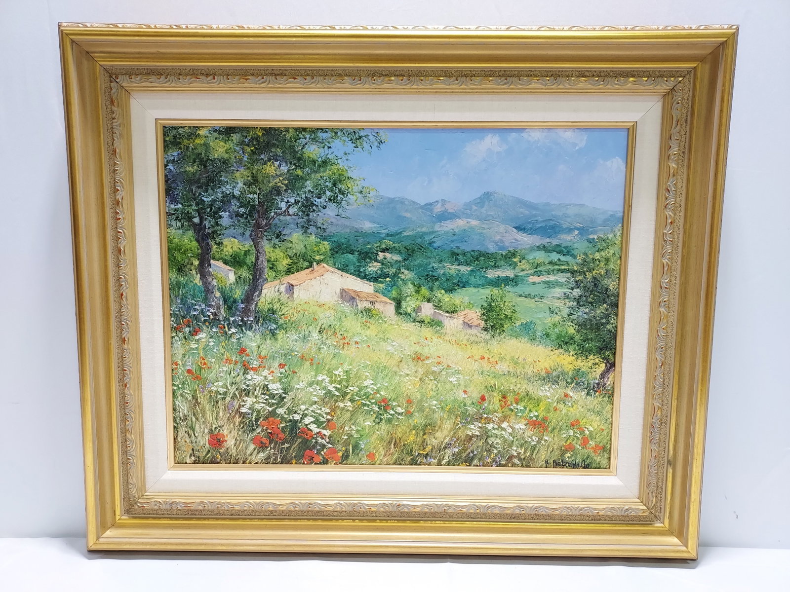 ROGER BOLZONELLO OIL ON CANVAS PAINTING: COQUELICO: Roger Bolzonello oil on canvas painting depicting a countryside meadow with buildings in the background and mountains in the distance, titled on back of canvas and on label affixed verso "Coquelicots 