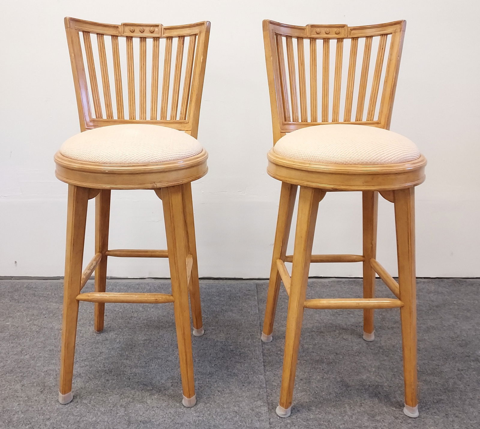 PAIR CHARLES POLLOCK BLONDE WOOD BARSTOOLS: Pair of Charles Pollock blonde wood barstools, each measuring a total of 45" tall x 18.25" wide and 19" deep. Condition: minor nicks and marks to finish - mostly around the footrests, see images. Weig