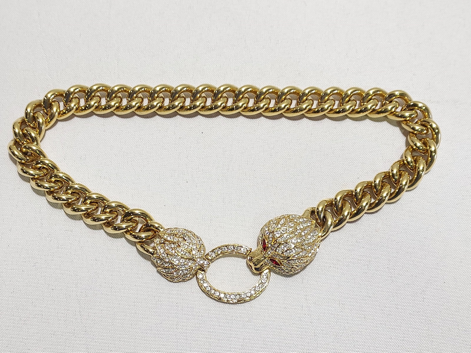 H556 Nina Ricci crystal encrusted lion head neckla: Nina Ricci crystal encrusted lion head necklace with door knocker style clip on clasp. Part of the "Duchess Of Windsor" collection. Gold tone metal. 4th quarter 20th C. Dimensions: Length approx. 19"