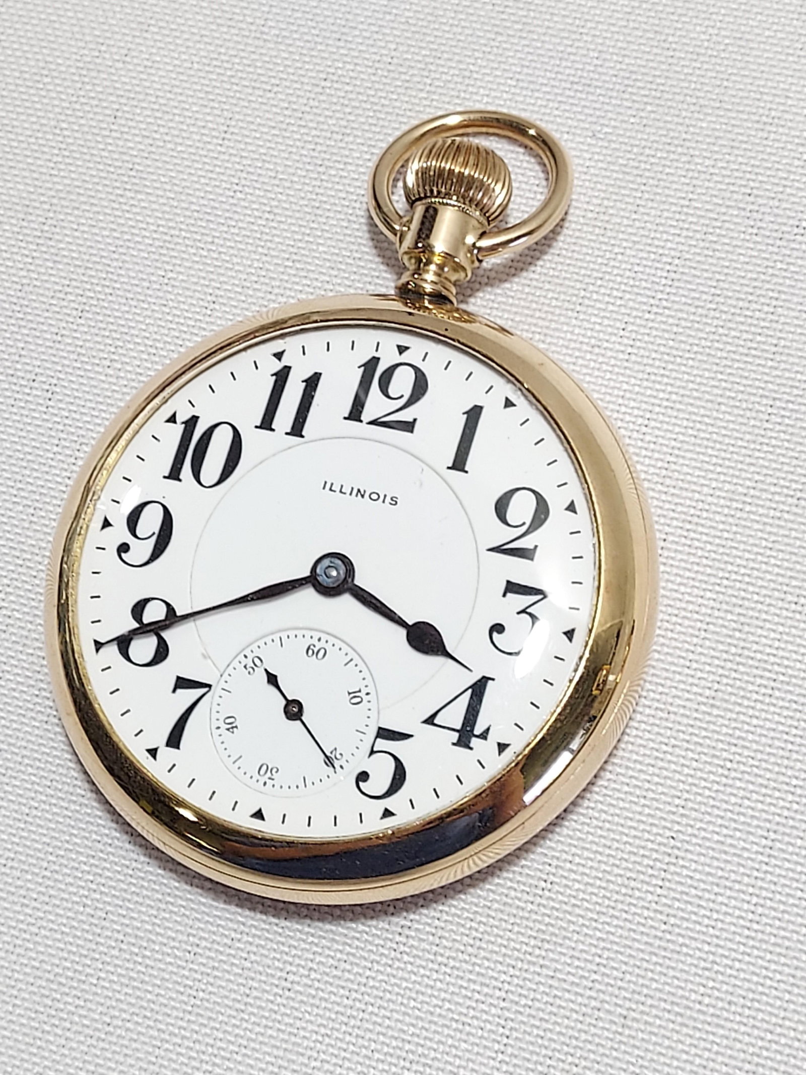 H513 Illinois brand gold filled pocket watch: Illinois brand gold filled pocket watch with white enamel Arabic numeral dial and separate seconds dial. Personalized engraving verso "BCH". 21 jewel, sweep second hand. s16. Running and in good worki