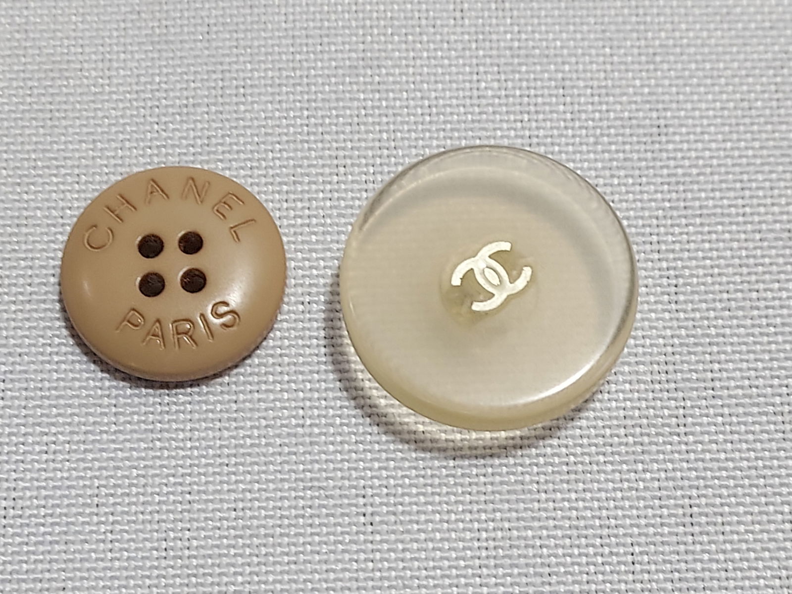 H569 Two Chanel buttons: Two Chanel buttons: one clear acrylic cc logo and one opaque beige acrylic