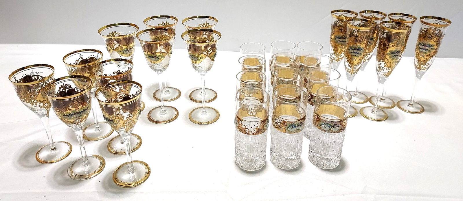 H301 28 pc Czech Rep Crystal Floral Stemware: 28 pc Czech Republic crystal stemware with relief decorated porcelain flowers and gold enamel. 5 large wine stems, 5 small wine stems, 6 champagne flutes, and 12 cut and decorated tumblers. Unsigned. 