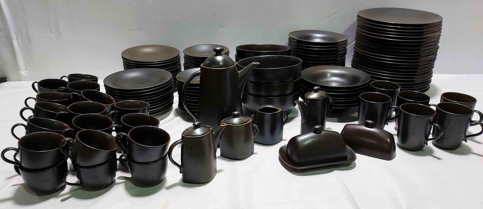 H147 Stymeist Craftworks Dinnerware: Stymeist Craftworks Dinnerware in 'Piano' colors. 23 Dinner plates 11" - 4 w/ chips, 18 side plates 8.5", 21 soup bowls2" x 9", 6 serving bowls 8" x 4", 4 mugs, 23 saucers 6", 28 cups, covered butter