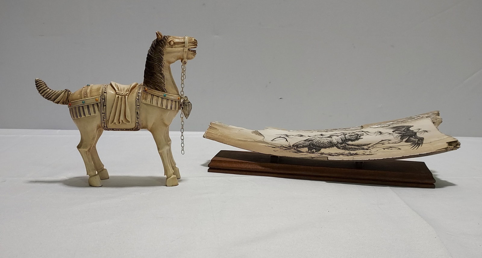 H371 Chinese ivory figure & fossilized ivory scrim: A Chinese ivory figure carved to depict a Tang style horse with inlaid semi-precious stones to include coral, and turquoise. The second appears to be walrus tusk ivory scrimshaw with a bear and eagle,