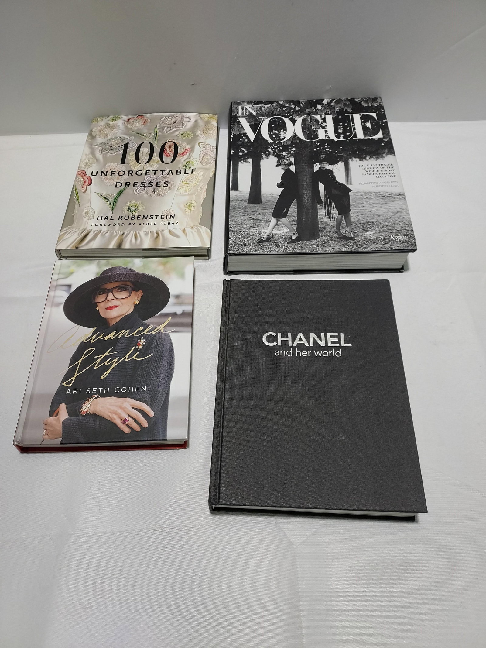 H1588 4 books - history and fashion: 4 books: 100 Unforgettable Dresses by Hal Rubenstein. Published 2011 by Harper Design, an Imprint of Harper Collins Publishers. ISBN 978-0-06-115166-8; In Vogue: An Illustrated History of the World's 