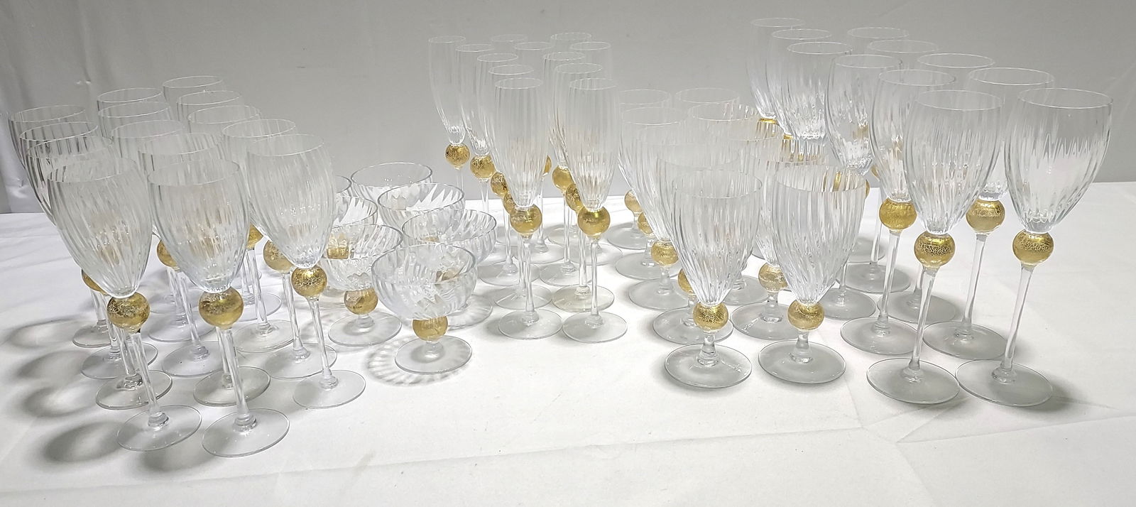 H140 Union Street Manhattan Gold Stemware 54pc: Union Street Manhattan Gold Stemware 54pc . 12 Champagne flutes 10.5" x 2", 14 Small Wine 9.5" x 2.5", 11 Large Wine 10.5 x 2.5, 10 Water 7.5" x 3", and 7 Coupes 4" x 4".