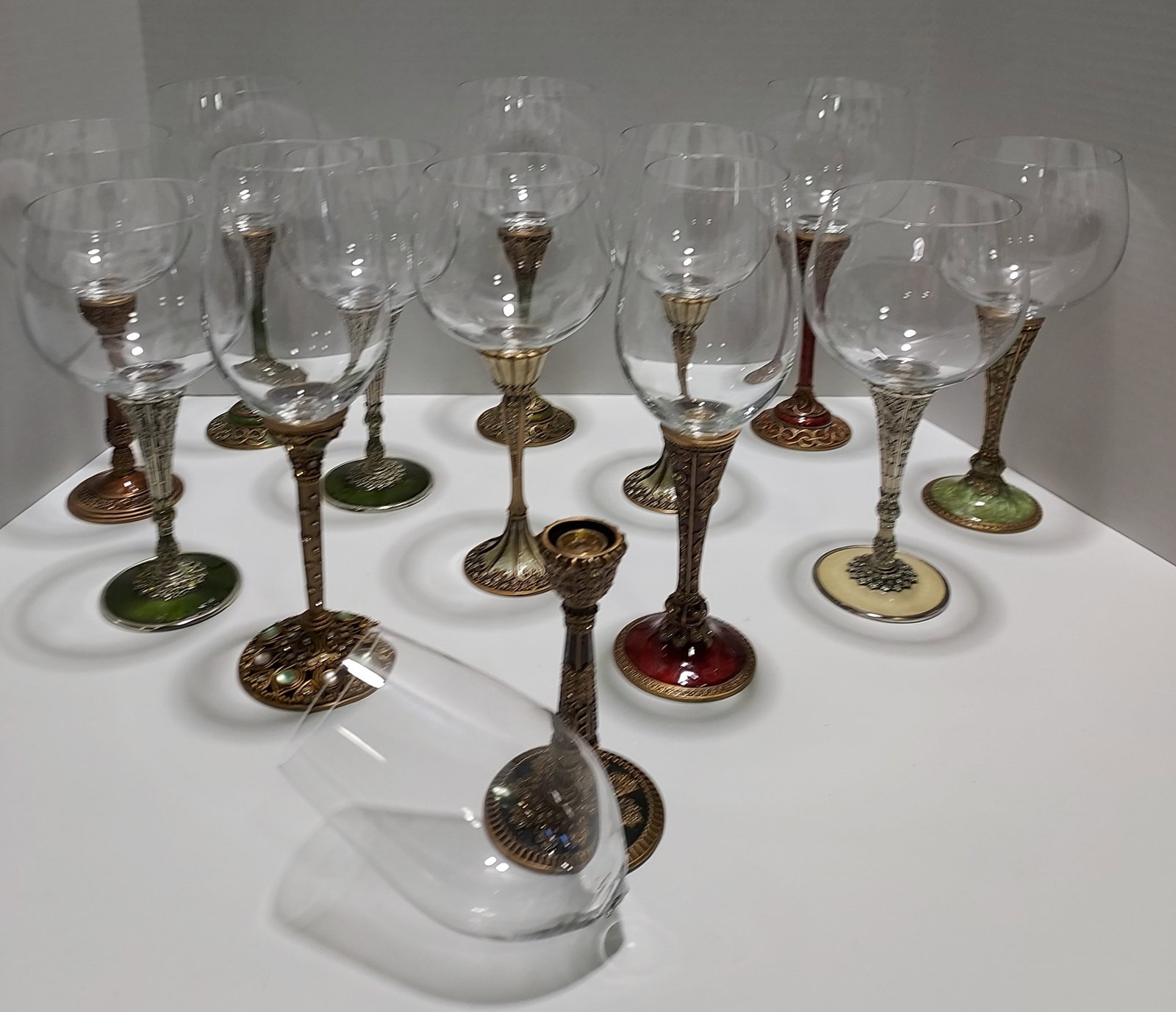 H4 & H299 Edgar Berebi Stemware & extras: 13 Edger Berebi wine stems. Glass bowls and stems are sold separately and are inter-changable. Each stem has either gold or silver wash over a metal base, colorful enameling and applied Swarovski crys
