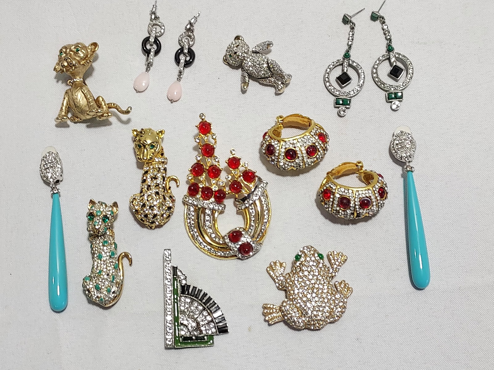 H595 11 pc signed and unsigned costume jewelry: 11 pc signed and unsigned costume jewelry: 1- a Deanna Hamro basket shaped rhinestone and faux ruby cabochon clip-on earrings. Glue residue on several cabochons and missing some small rhinestones; 2- 