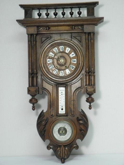 19th C VIENNA WALL CLOCK: 19th century Vienna wooden wall clock. Features a clock, thermometer and barometer. Wooden clock face with enameled metal numbers, and brass time and strike mechanism. Thermometer is enameled in white