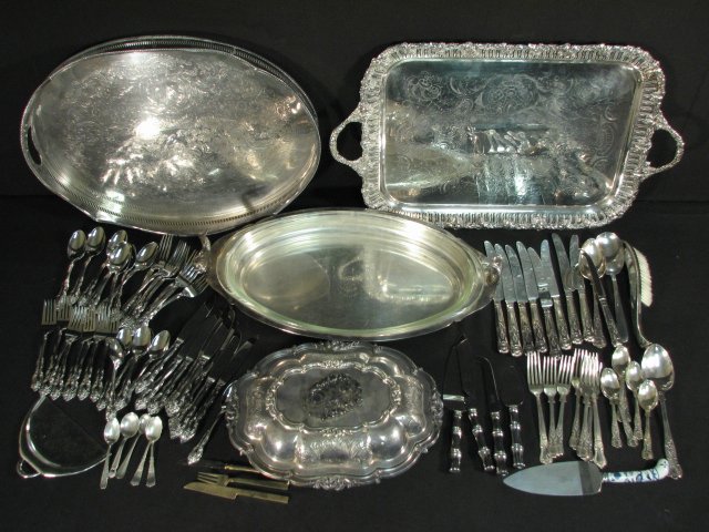 ASSORTED SILVER PLATED TABLE WARES & UTENSILS: Lot of assorted silver plated table wares and utensils. Includes a 13.5" wide covered server, a 21" wide silver plated figural tray with glass insert, a 20" wide handled tray, a 24" wide handled tray 