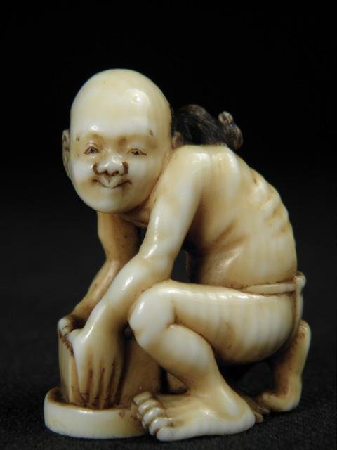 JAPANESE CARVED IVORY NETSUKE: RAT CATCHER: Japanese carved ivory netsuke depicting a rat catcher and escaped rat. Circa early 19th century. Marked with artist's signature on base, and with loop holes on man's lower back. Condition: minor disco