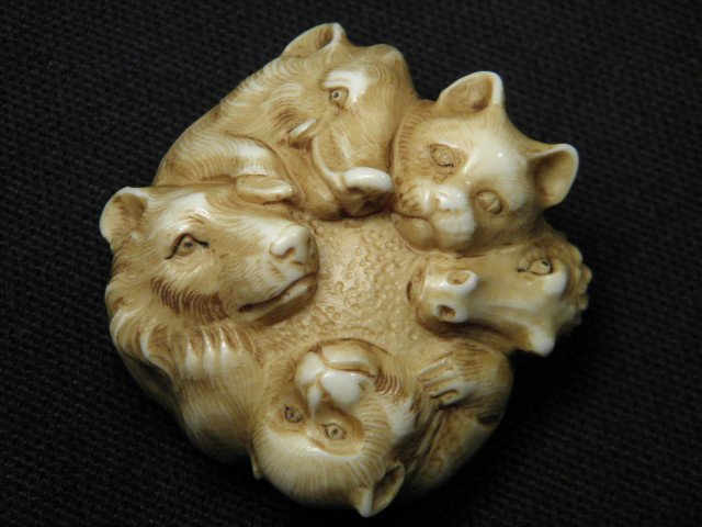 JAPANESE CARVED IVORY NETSUKE: FIVE ANIMALS: Japanese carved ivory netsuke depicting a bear, a boar, a panther, a crocodile, and a monkey. Signed by the artist on verso near loop holes. Condition: very minor discoloration as expected from age, s