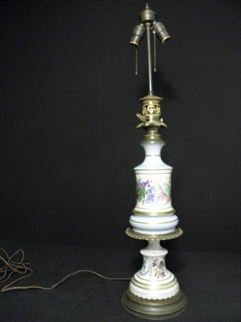 OLD PARIS HAND PAINTED PORCELAIN TABLE LAMP: An Old Paris hand painted porcelain table lamp. Two part porcelain design, hand painted with florals, and with embossed and pierced gilt brass mounts. Two-bulb fixture with independent pulls. Conditio